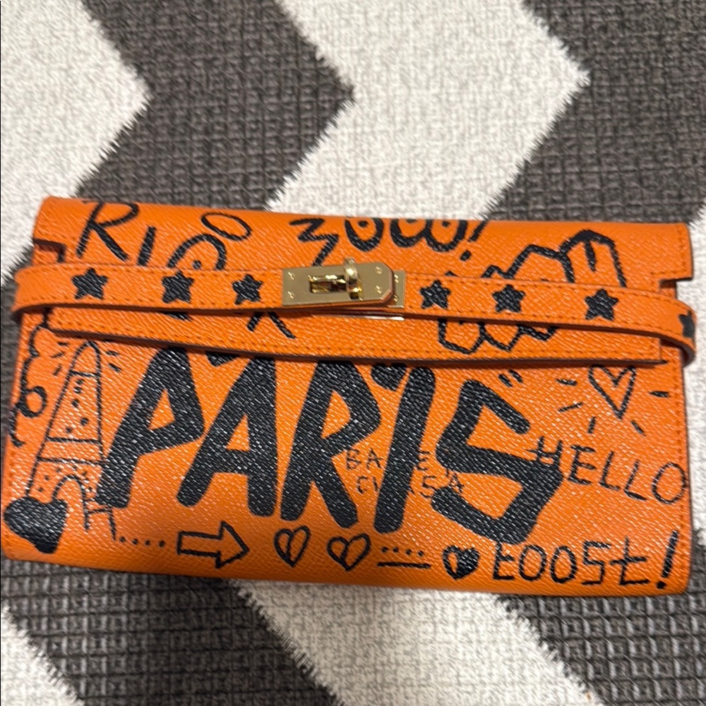 Vibrant Orange Parisian Clutch with Artistic Graffiti Design